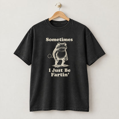 Black Comfort Colors shirt on a hanger with Sometimes I Just Be Fartin frog design