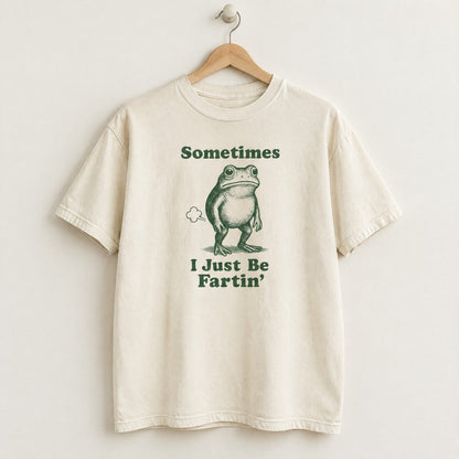 Ivory Comfort Colors shirt on a hanger with Sometimes I Just Be Fartin frog design