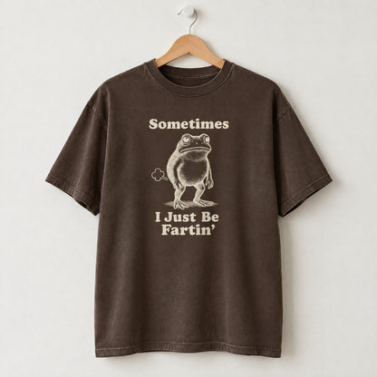 Espresso Comfort Colors shirt on a hanger with Sometimes I Just Be Fartin frog design