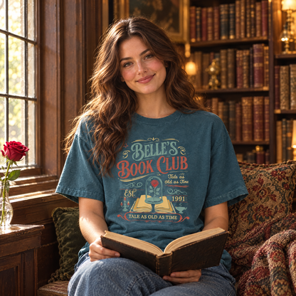 Woman wearing Blue Spruce Comfort Colors Belle's Book Club shirt reading in a vintage library