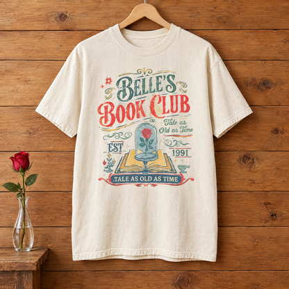 Belle's Book Club Comfort Colors shirt in Natural Ivory on a wooden hanger