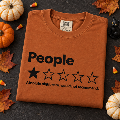 Funny introvert Comfort Colors tee in Yam, folded with Halloween pumpkins