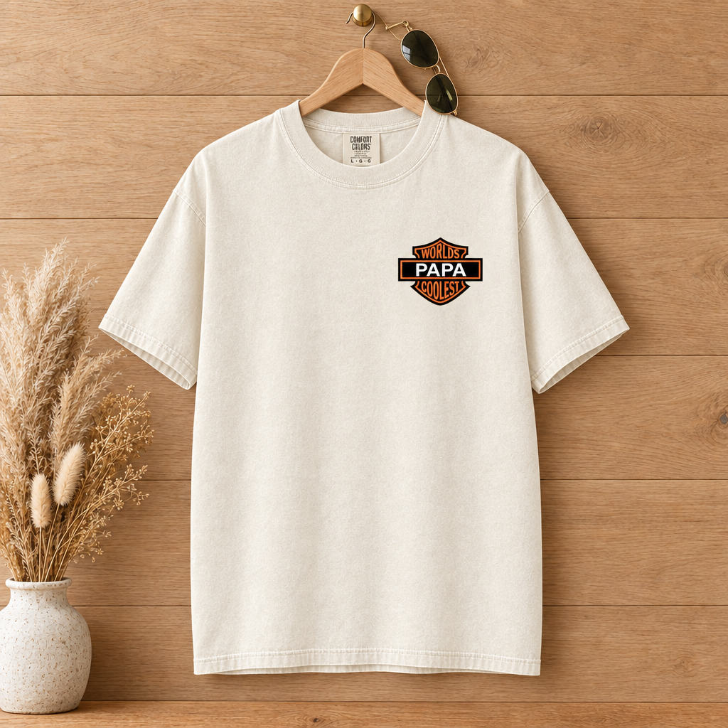 Worlds Coolest Papa custom name Comfort Colors shirt in Ivory on a wooden hanger