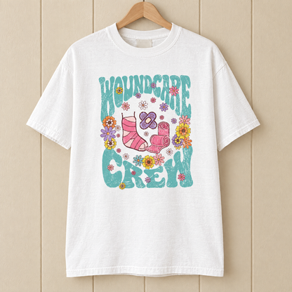 Wound Care Crew Comfort Colors shirt in White on a wooden hanger