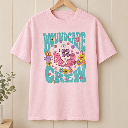 Wound Care Crew Comfort Colors shirt in Blossom pink on a wooden hanger