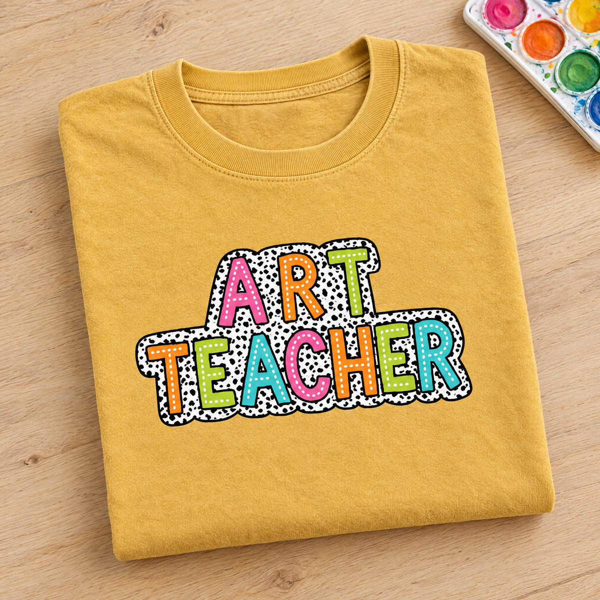 Art Teacher Comfort Colors tee in Mustard, neatly folded