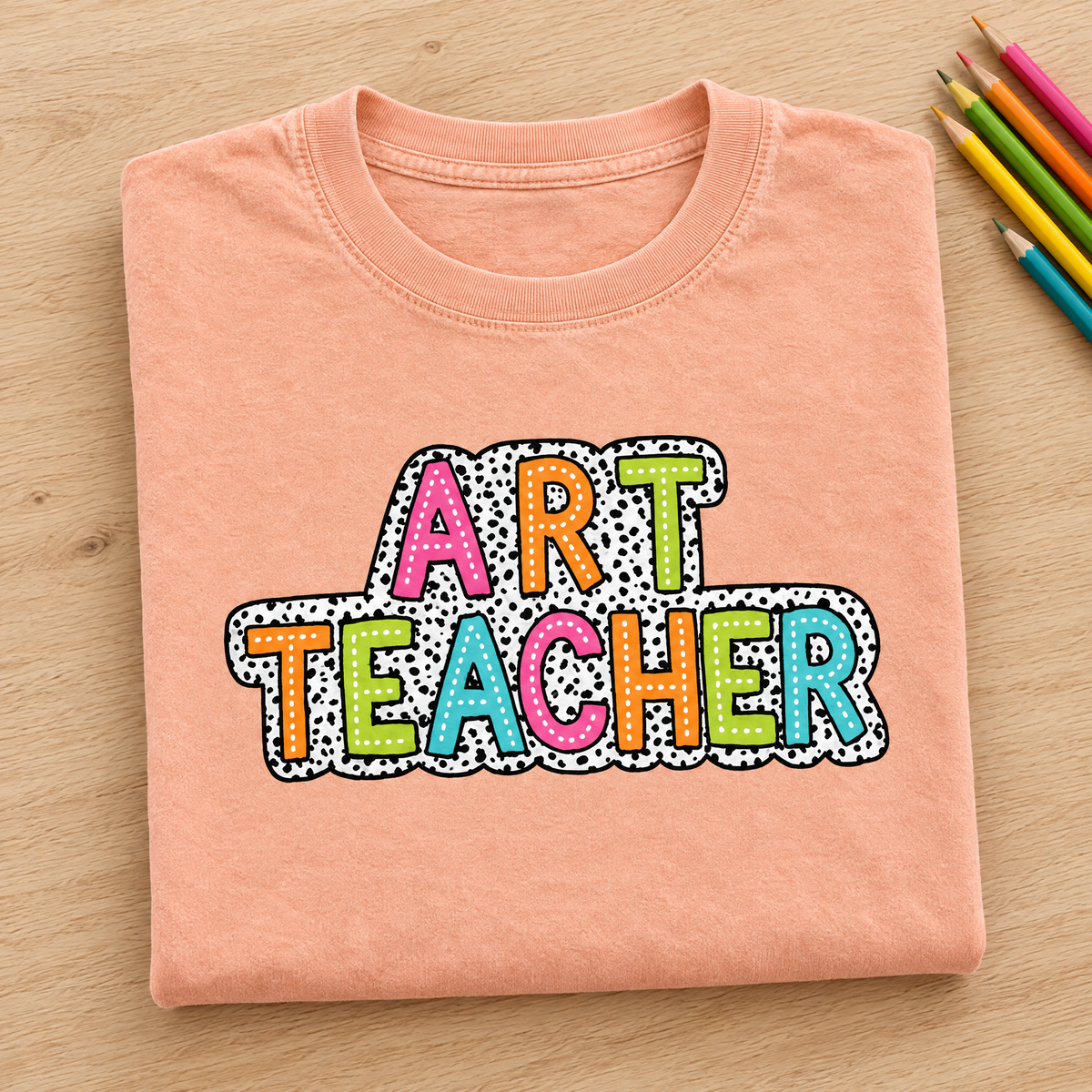 Art Teacher Comfort Colors tee in Peachy, neatly folded