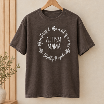 Autism Mama Comfort Colors shirt in Espresso on a wooden hanger