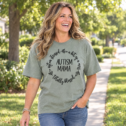 Mom wearing a Sage Comfort Colors Autism Mama shirt walking on a sunny sidewalk