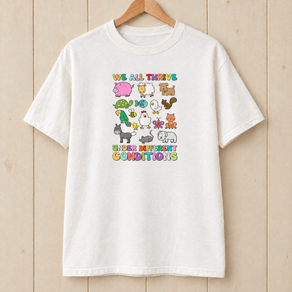 We All Thrive Under Different Conditions Comfort Colors shirt in White on a wooden hanger