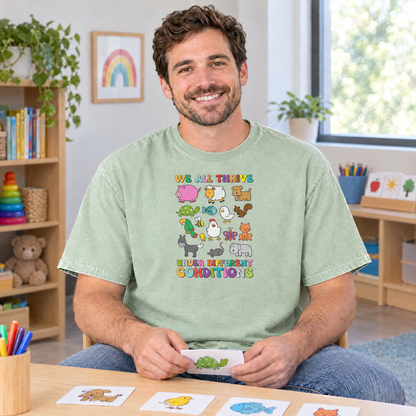 Speech therapist wearing a Light Green Comfort Colors We All Thrive shirt at a therapy table with picture cards