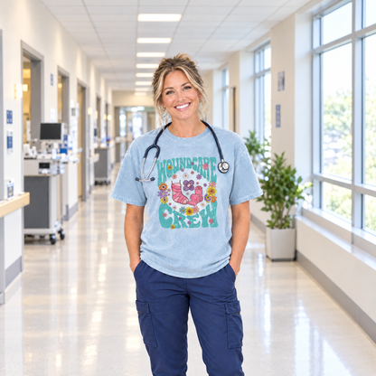 Woman nurse wearing a Chambray Comfort Colors Wound Care Crew shirt with a stethoscope in a hospital hallway