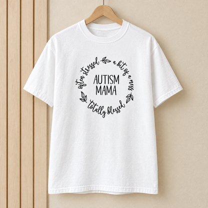 Autism Mama Comfort Colors shirt in White on a wooden hanger