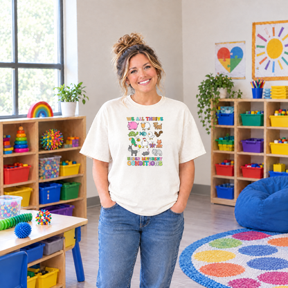 Special education teacher wearing an Ivory Comfort Colors We All Thrive Under Different Conditions shirt in an inclusive classroom