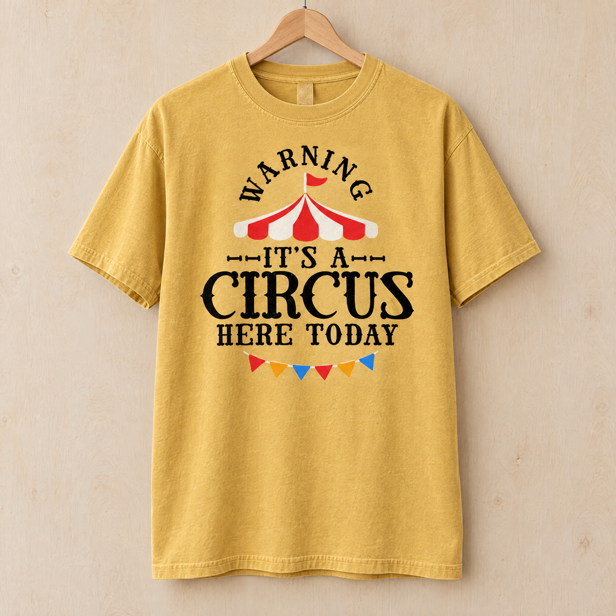 Warning It's A Circus Here Today shirt in Mustard Comfort Colors, on a wooden hanger