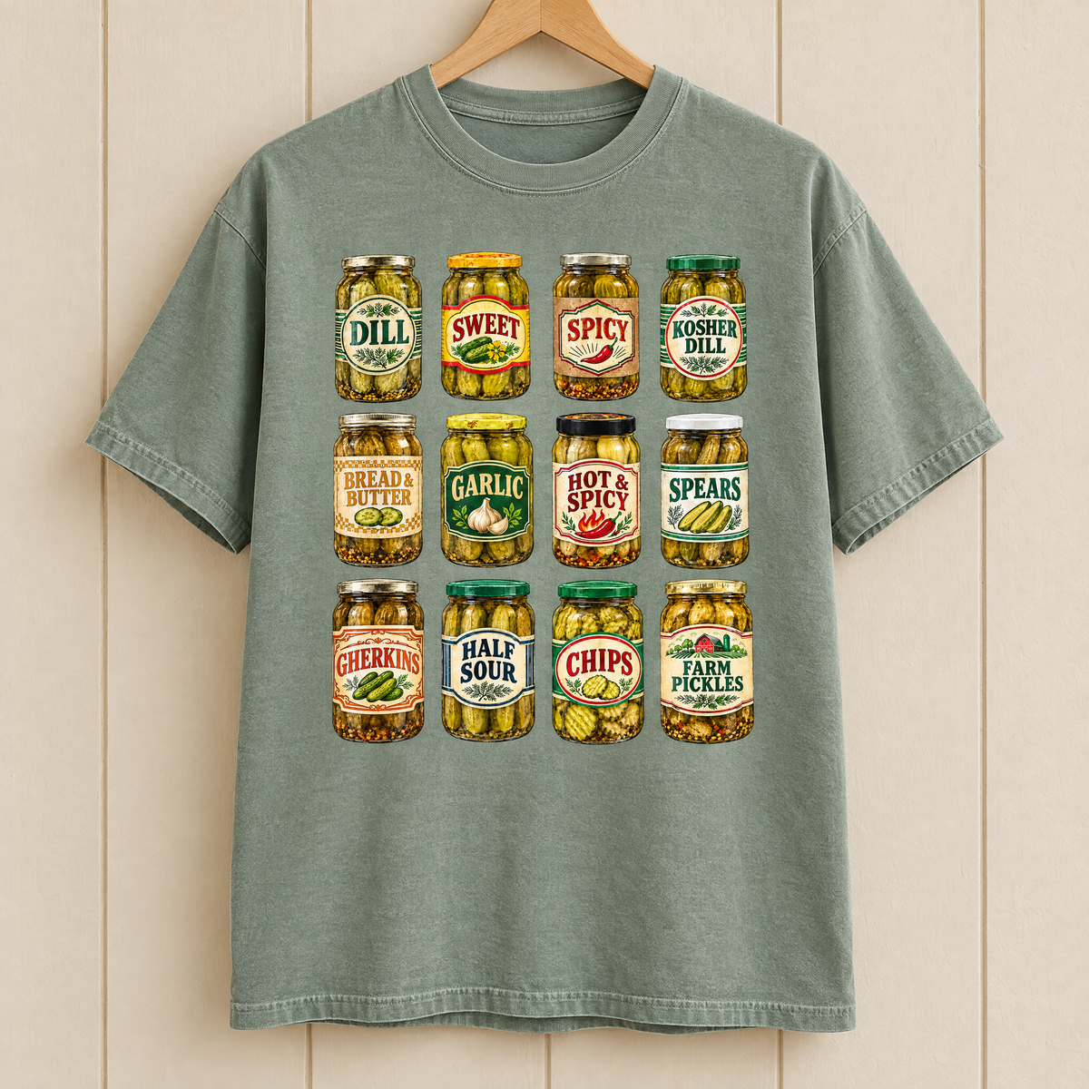 Pickle jar shirt in Sage Comfort Colors, on a wooden hanger
