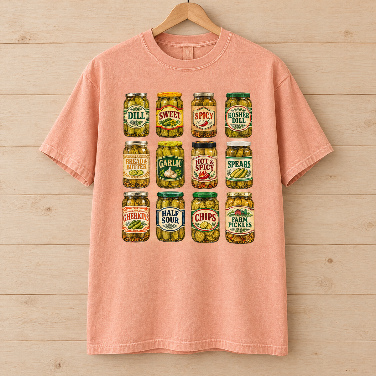Pickle jar shirt in Peachy Comfort Colors, on a wooden hanger