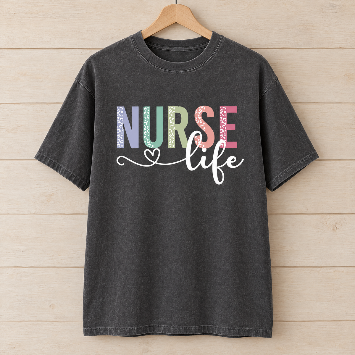 Nurse Life shirt in Pepper Comfort Colors, on a wooden hanger