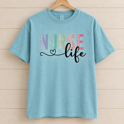 Nurse Life shirt in Lagoon Blue Comfort Colors, on a wooden hanger