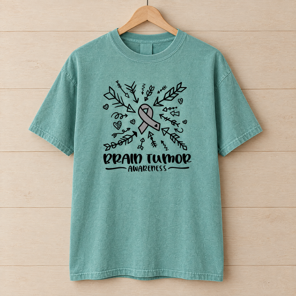 Brain Tumor Awareness shirt in Seafoam Comfort Colors, on a wooden hanger