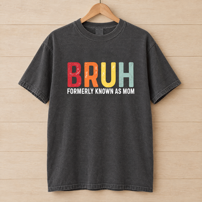 Bruh Formerly Known As Mom shirt in Pepper Comfort Colors, on a wooden hanger