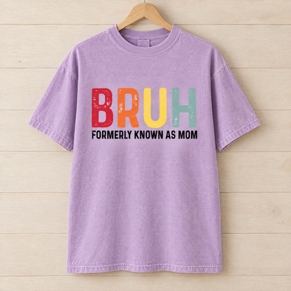 Bruh Formerly Known As Mom shirt in Orchid Comfort Colors, on a wooden hanger
