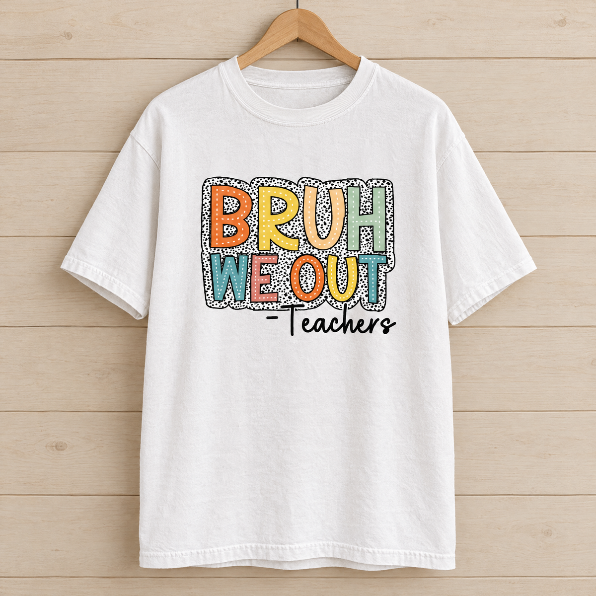 Bruh We Out Teachers shirt in White Comfort Colors, on a wooden hanger