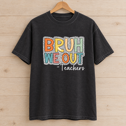 Bruh We Out Teachers shirt in Black Comfort Colors, on a wooden hanger