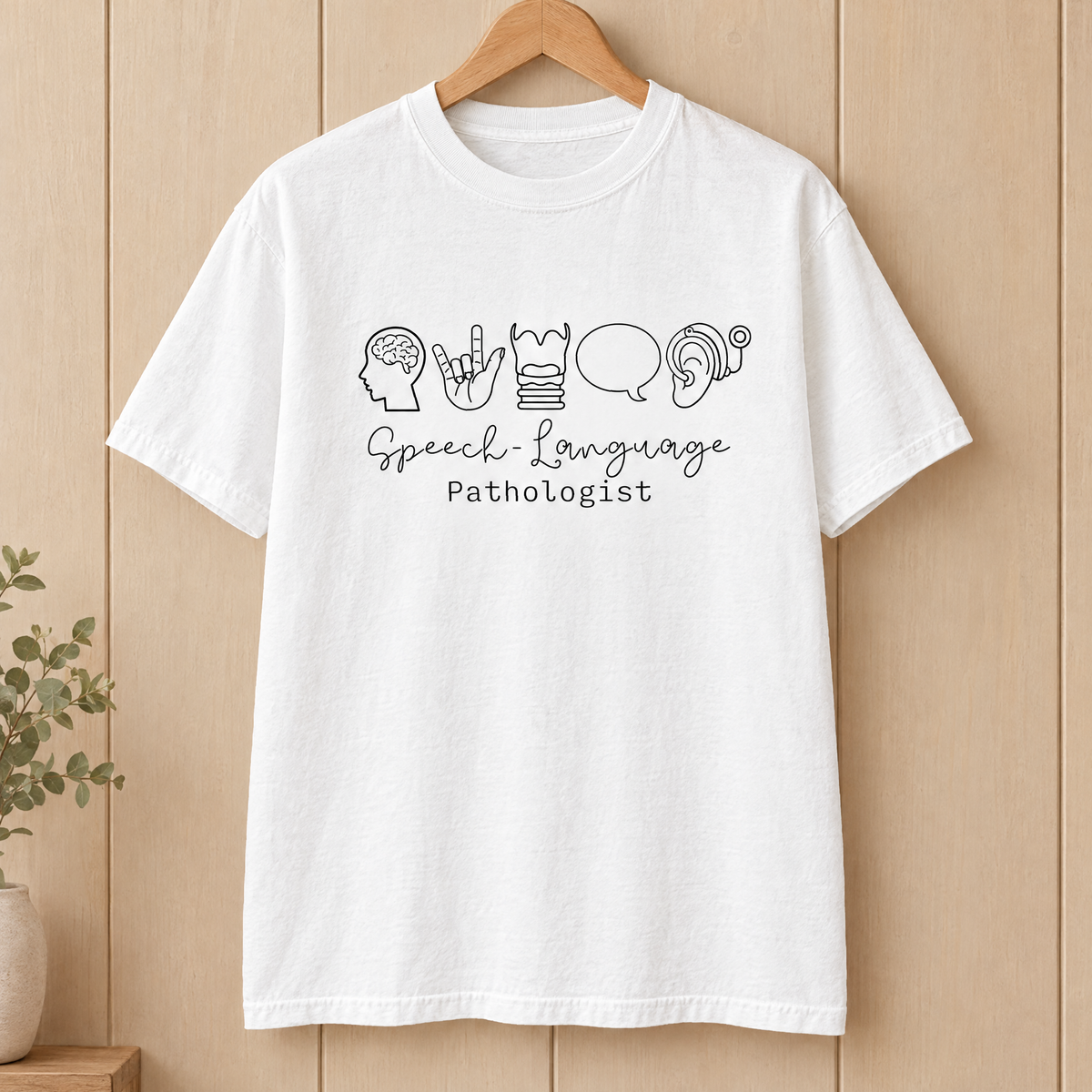 Speech Language Pathologist shirt in White Comfort Colors, on a wooden hanger
