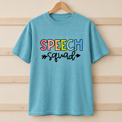 Speech Squad shirt in Lagoon Blue Comfort Colors, on a wooden hanger