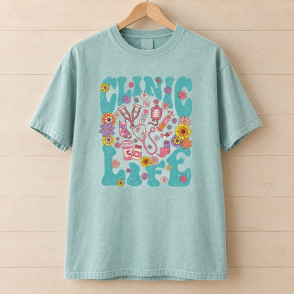 Clinic Life shirt in Seafoam Comfort Colors, on a wooden hanger