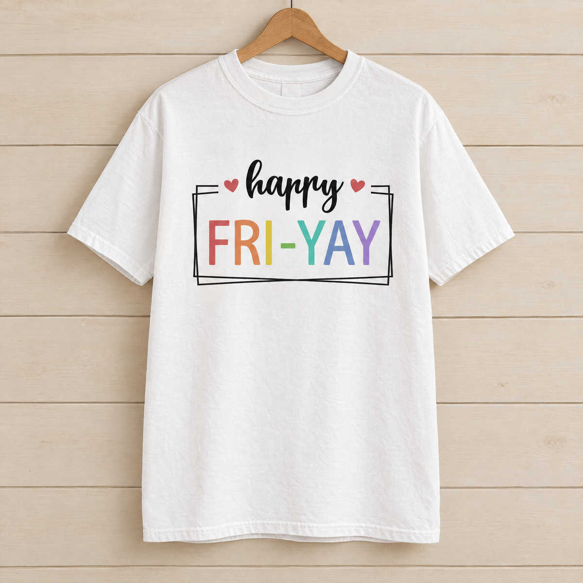 Happy Fri-Yay shirt in White Comfort Colors, on a wooden hanger