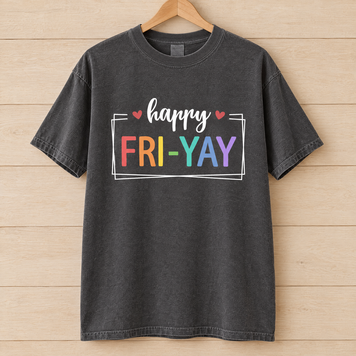 Happy Fri-Yay shirt in Pepper Comfort Colors, on a wooden hanger