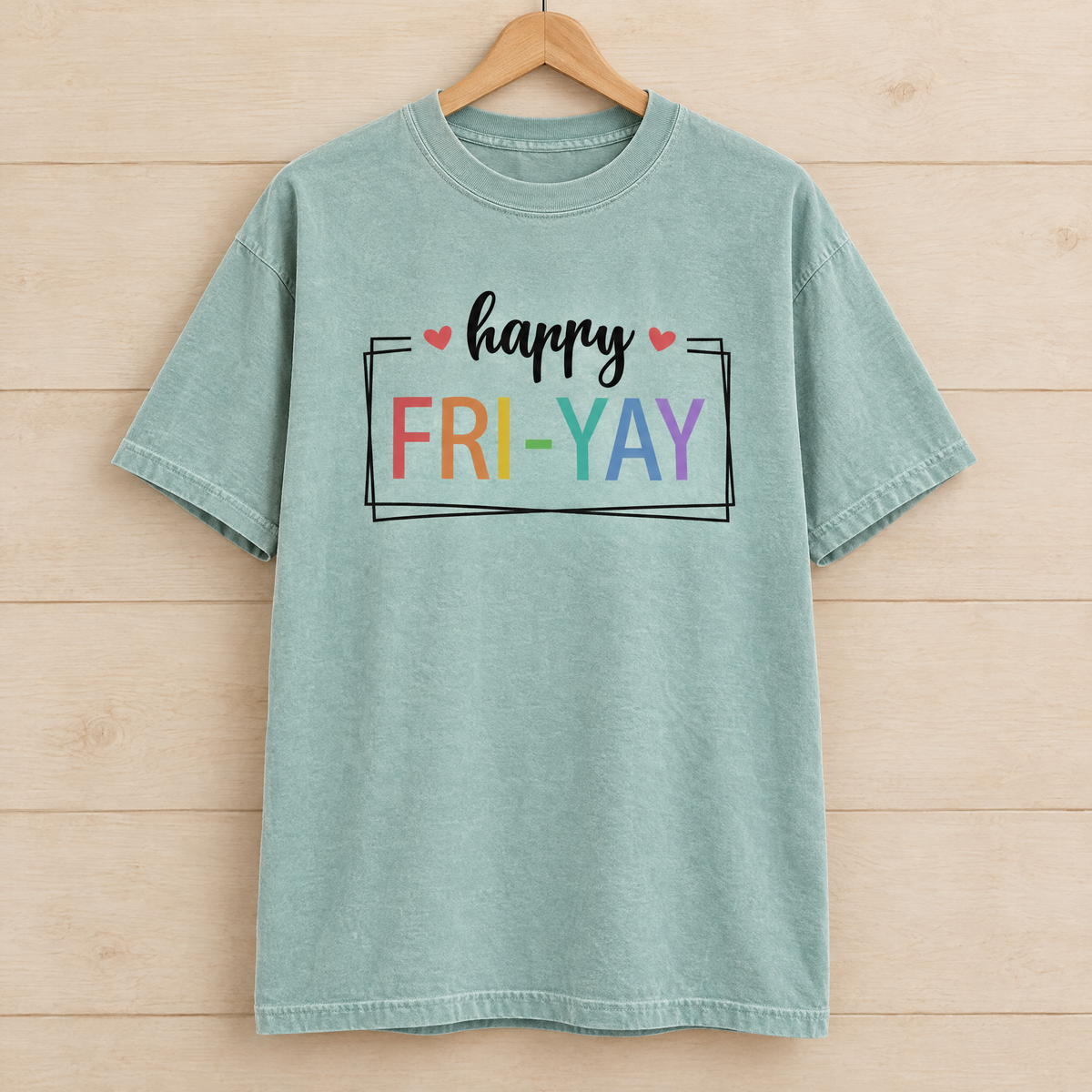Happy Fri-Yay shirt in Seafoam Comfort Colors, on a wooden hanger