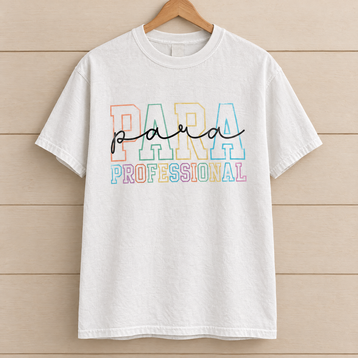 Paraprofessional shirt in White Comfort Colors, on a wooden hanger