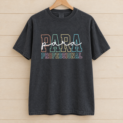 Paraprofessional shirt in Black Comfort Colors, on a wooden hanger