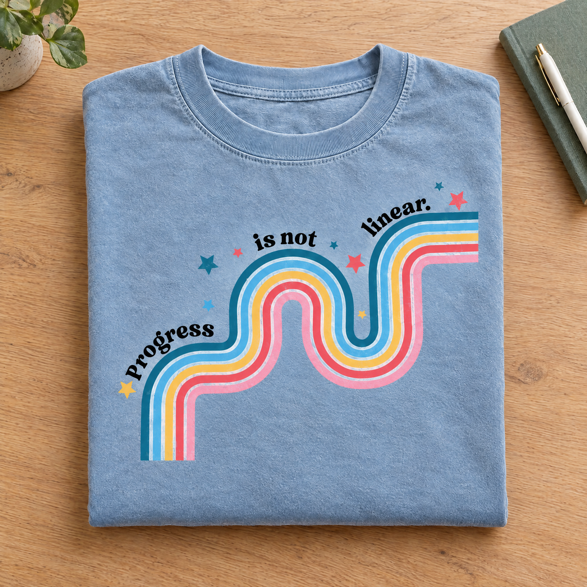 Progress Is Not Linear shirt in Chambray Comfort Colors, neatly folded