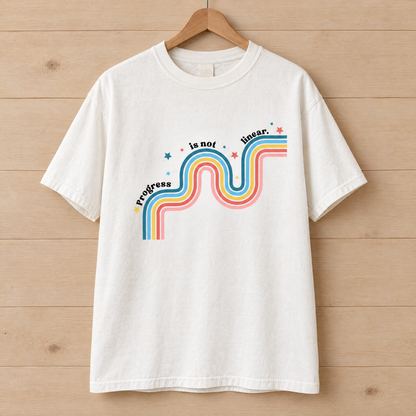 Progress Is Not Linear shirt in White Comfort Colors, on a wooden hanger