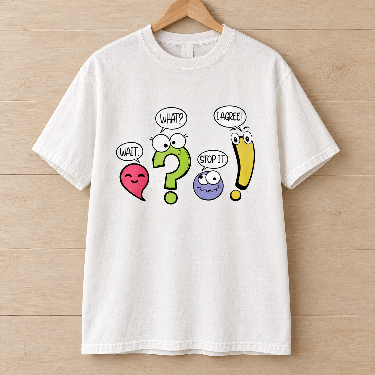 Punctuation shirt in White Comfort Colors, on a wooden hanger