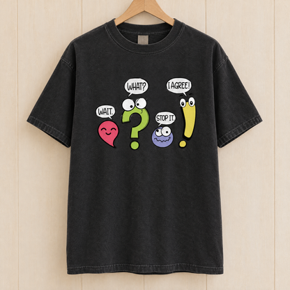 Punctuation shirt in Black Comfort Colors, on a wooden hanger