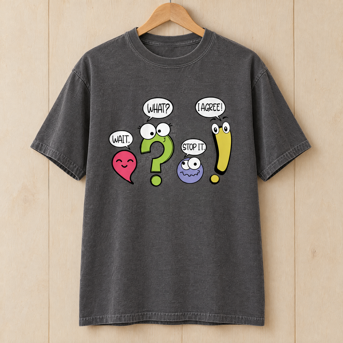 Punctuation shirt in Pepper Comfort Colors, on a wooden hanger