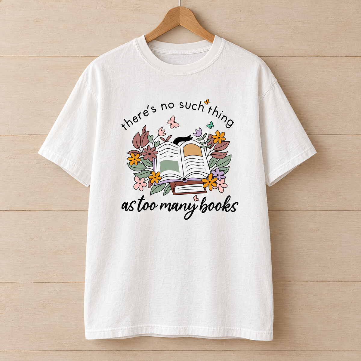 Too Many Books shirt in White Comfort Colors, on a wooden hanger