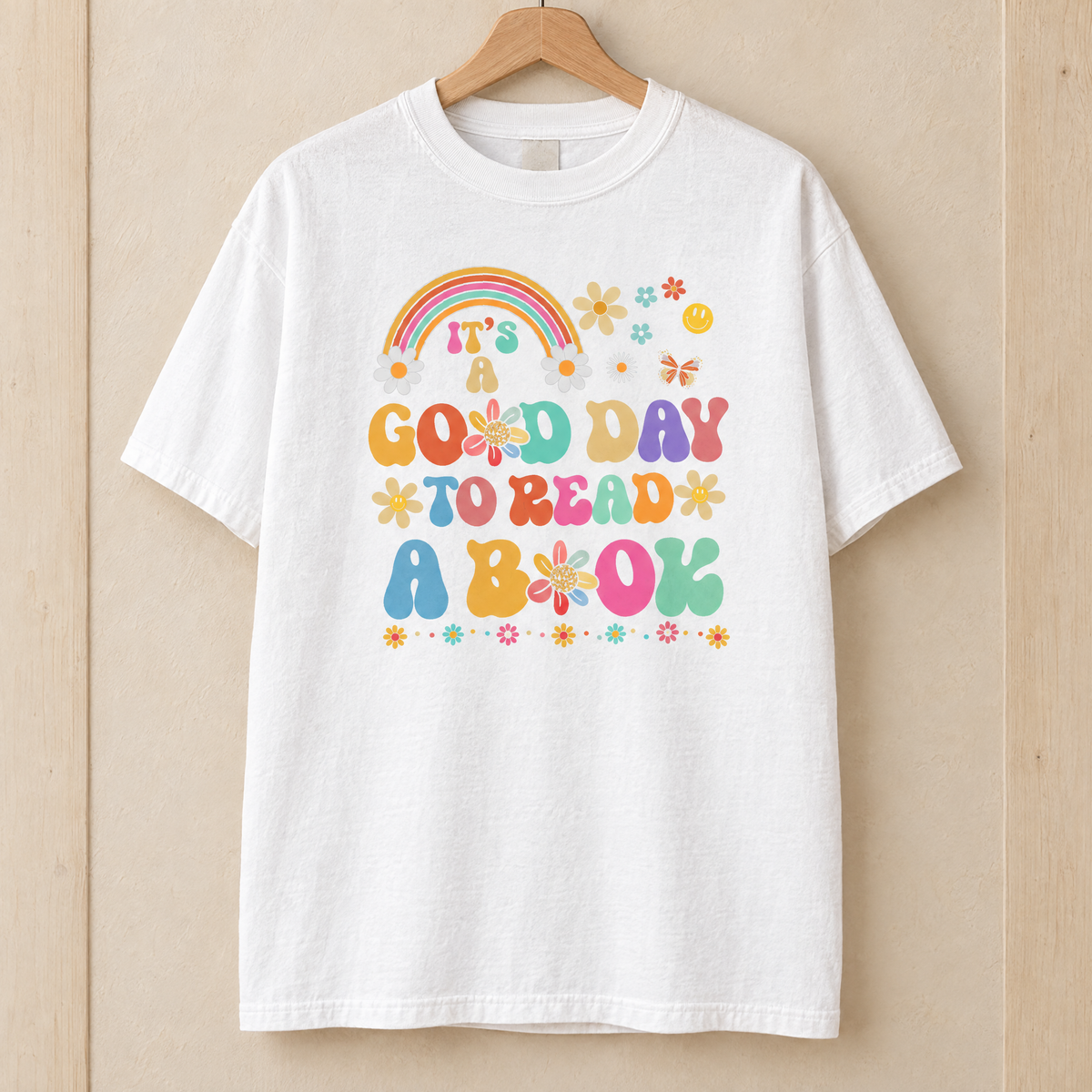 Good Day To Read A Book shirt in White Comfort Colors, on a wooden hanger