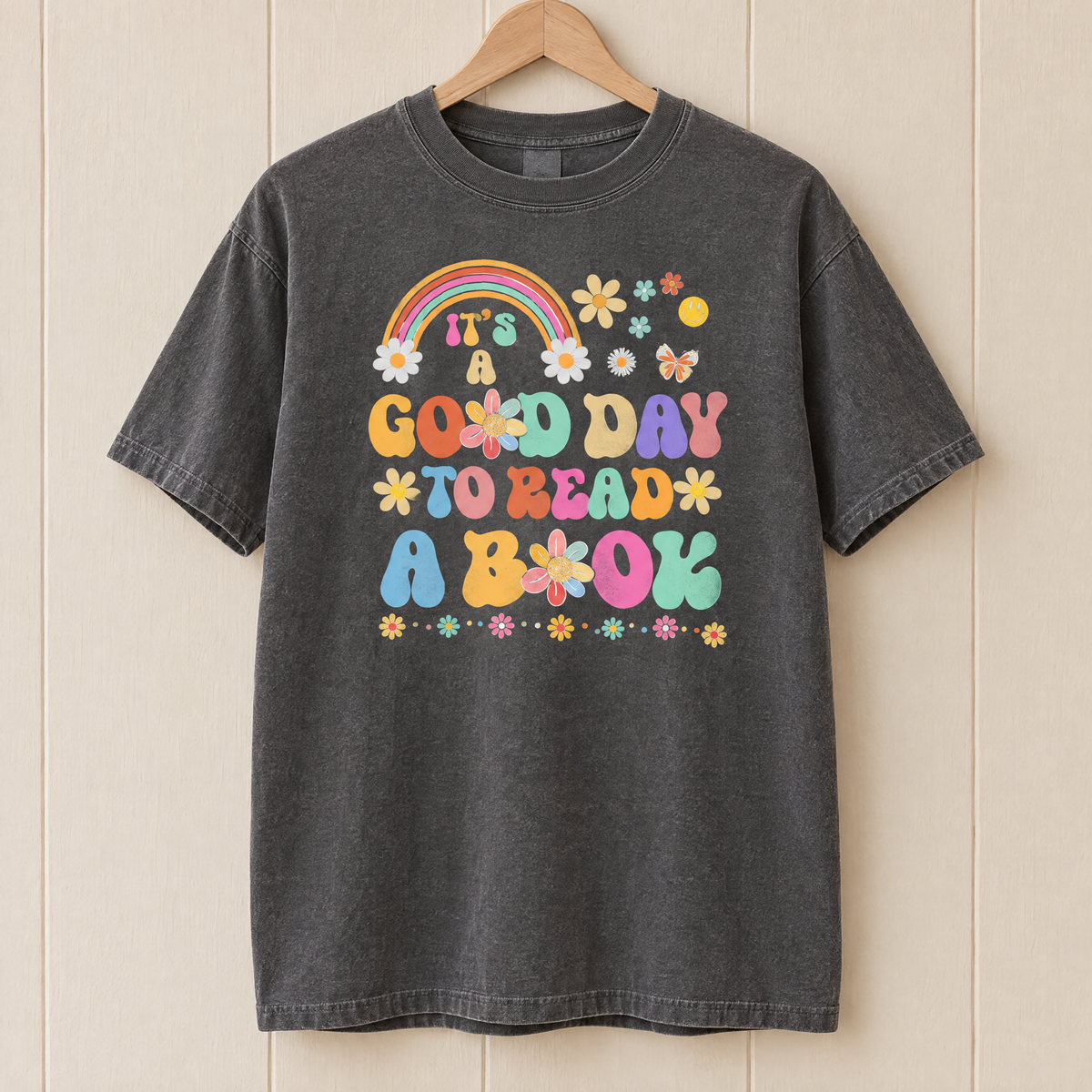 Good Day To Read A Book shirt in Pepper Comfort Colors, on a wooden hanger