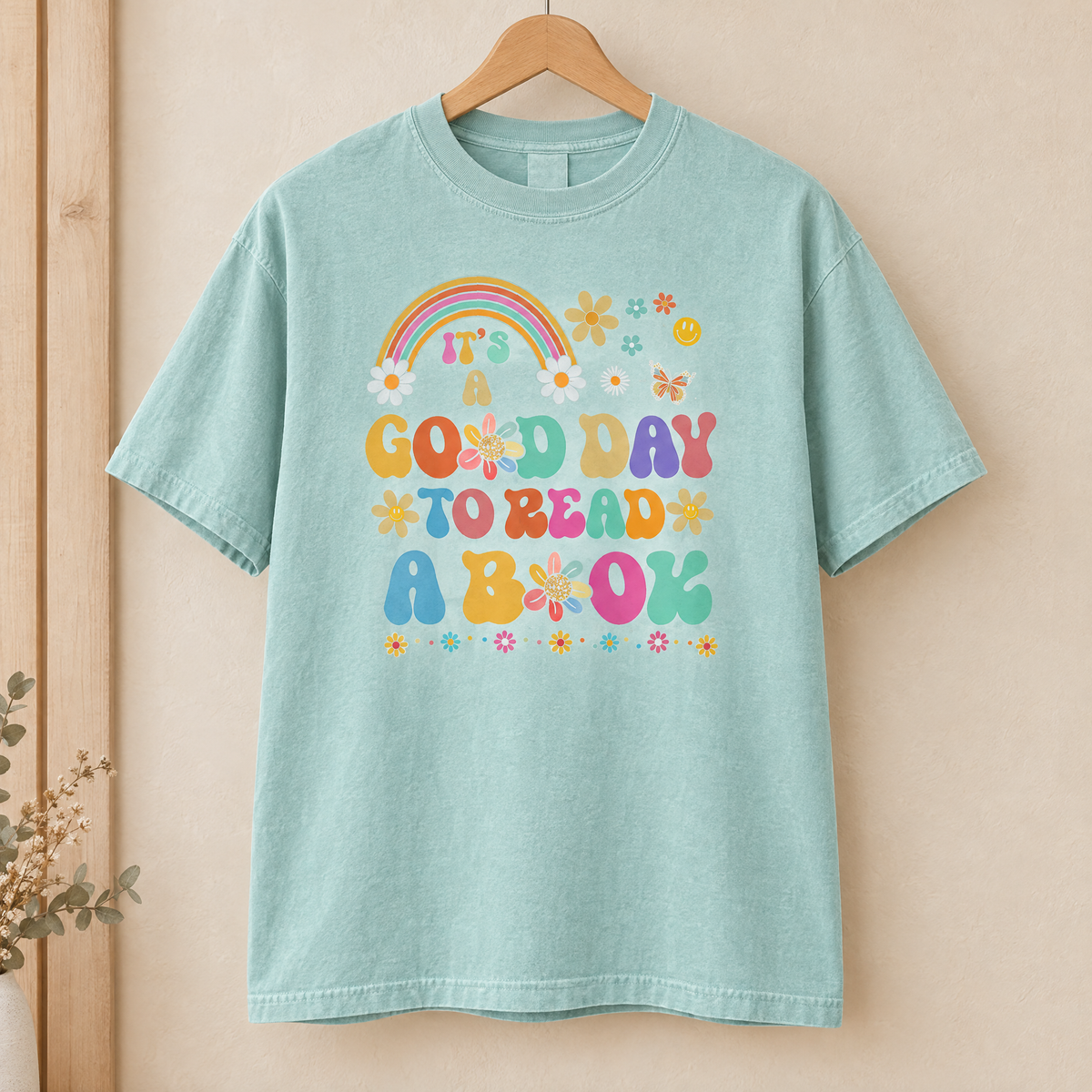 Good Day To Read A Book shirt in Seafoam Comfort Colors, on a wooden hanger