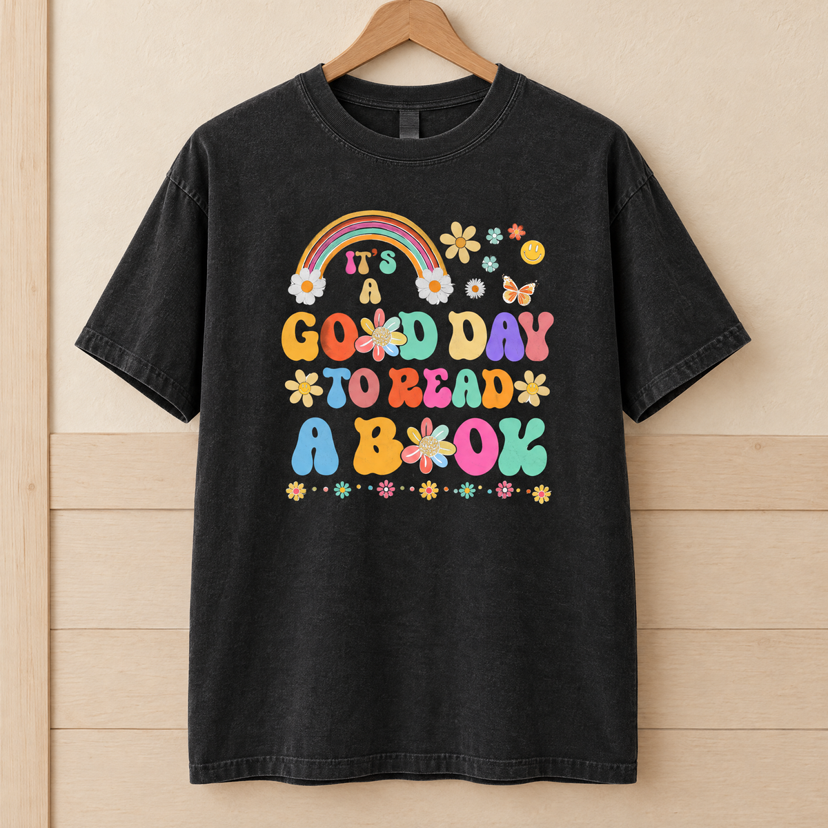 Good Day To Read A Book shirt in Black Comfort Colors, on a wooden hanger