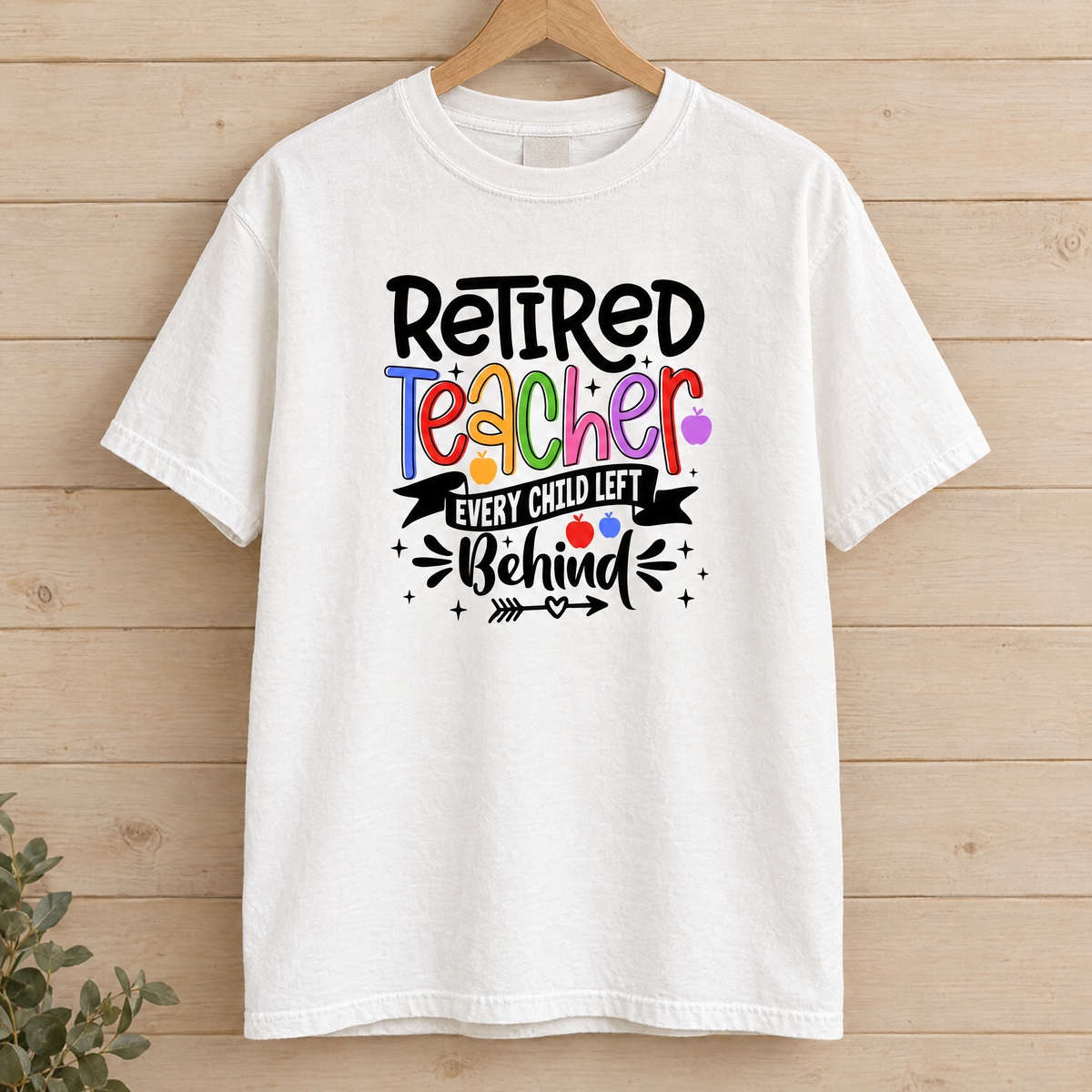 Retired Teacher shirt in White Comfort Colors, on a wooden hanger