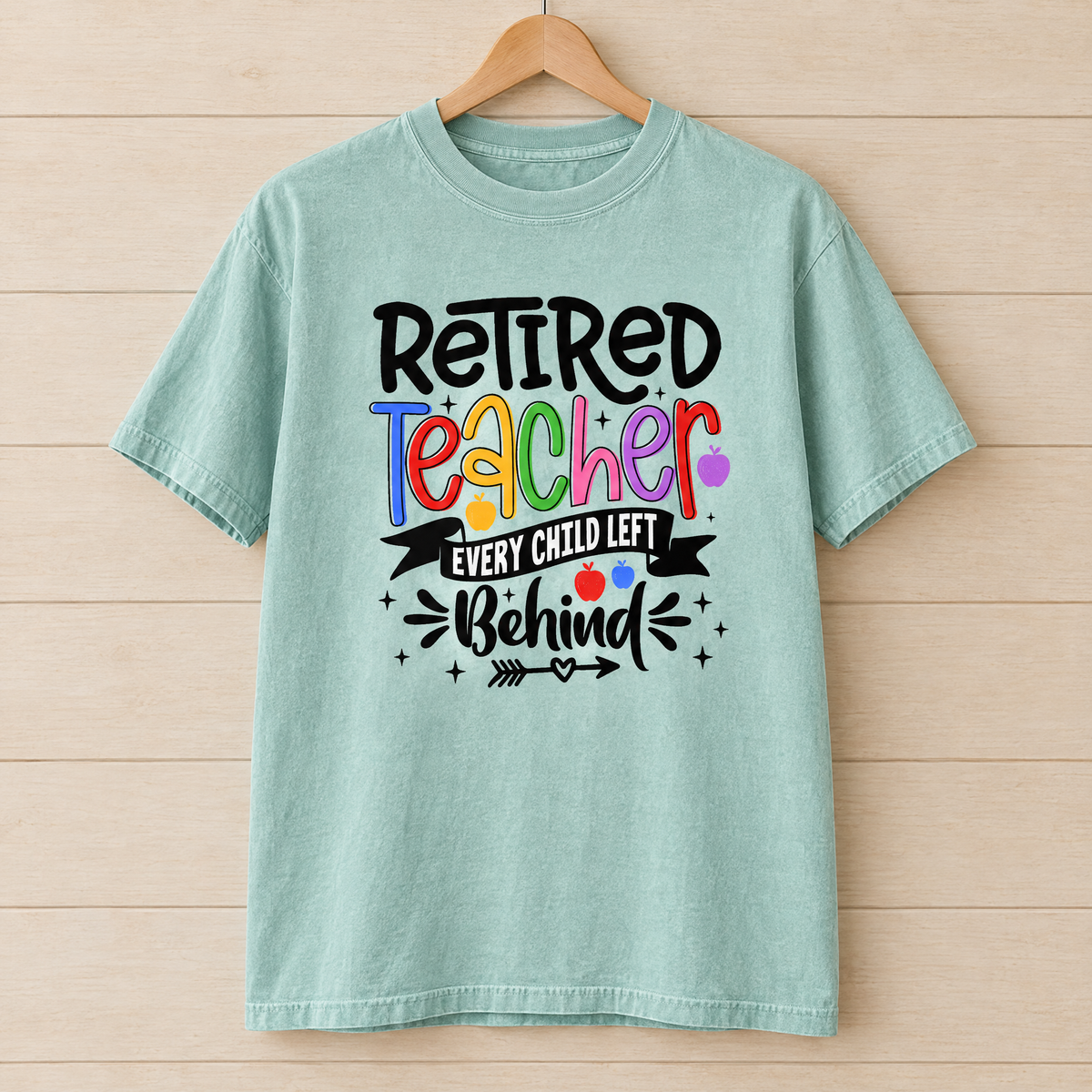 Retired Teacher shirt in Seafoam Comfort Colors, on a wooden hanger