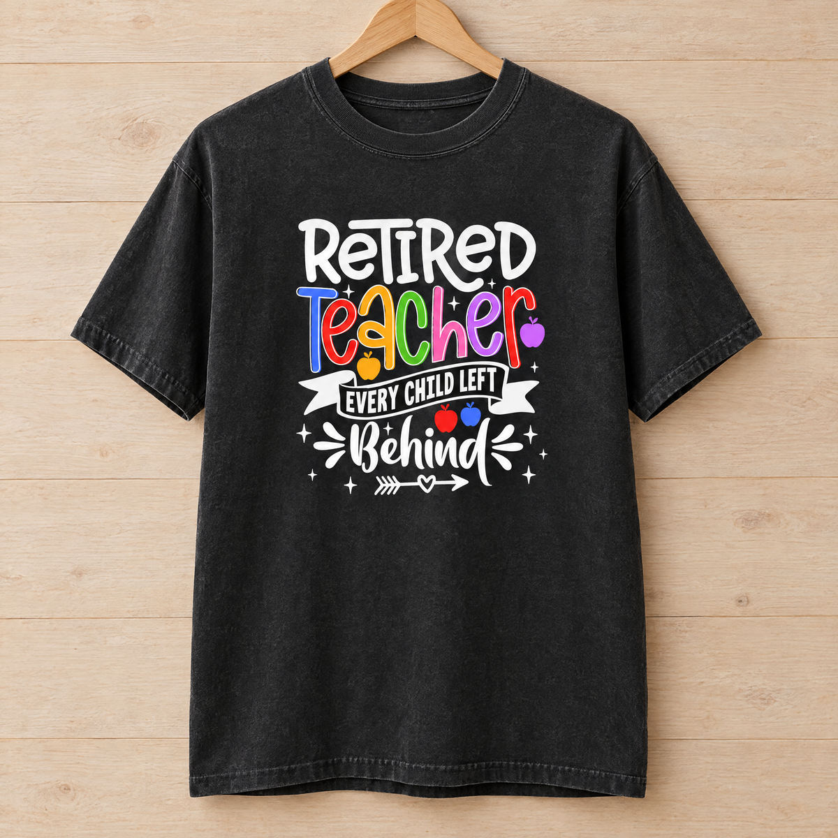 Retired Teacher shirt in Black Comfort Colors, on a wooden hanger