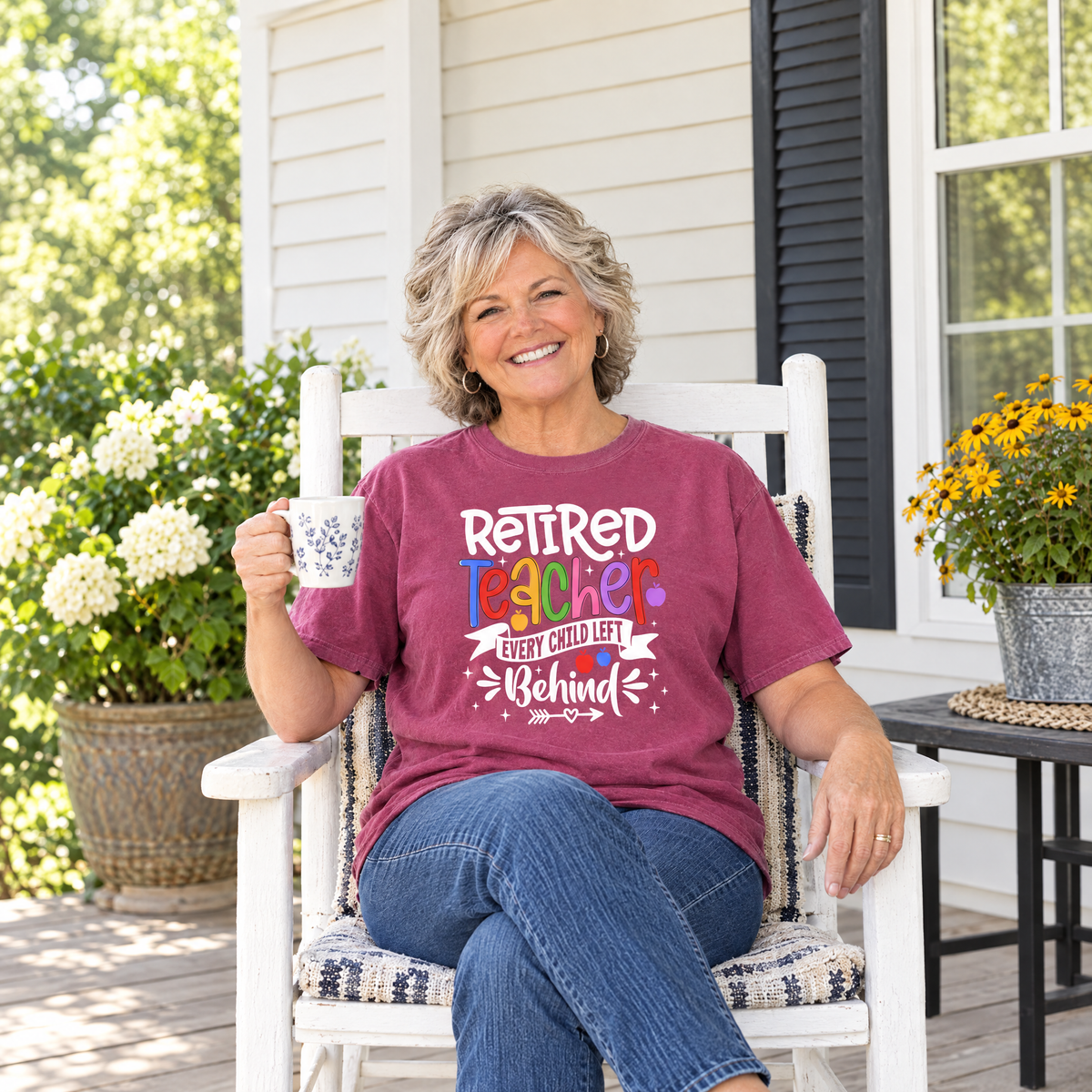 Retired Teacher shirt in Berry Comfort Colors, worn by a seated model